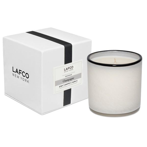 White Lafco Candle with a black rim scented "Champagne".