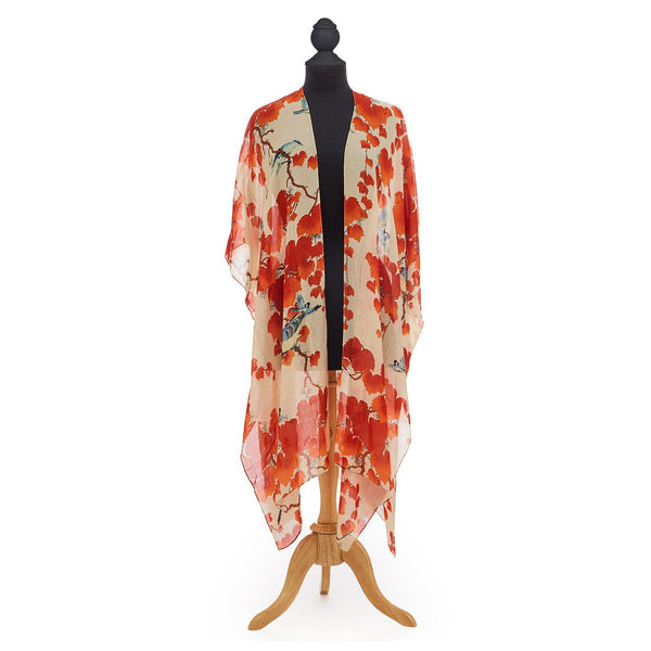Blossom Branch Long Kimono features red flower blossoms upon dark branches scattered across an ivory backdrop.  Loose and flowing, one size fits all. Knee length.