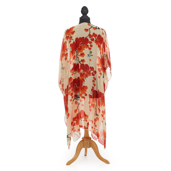Blossom Branch Long Kimono features red flower blossoms upon dark branches scattered across an ivory backdrop.  Loose and flowing, one size fits all. Knee length.
