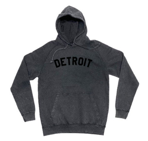 Ink Detroit Mineral Wash Black Hoodie with "Detroit" printed in black across the chest. Drawsting hood, kangaroo pocket.