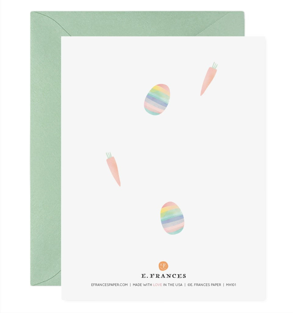 Back of Easter greeting card with carrots and rainbow easter eggs acattered about.
