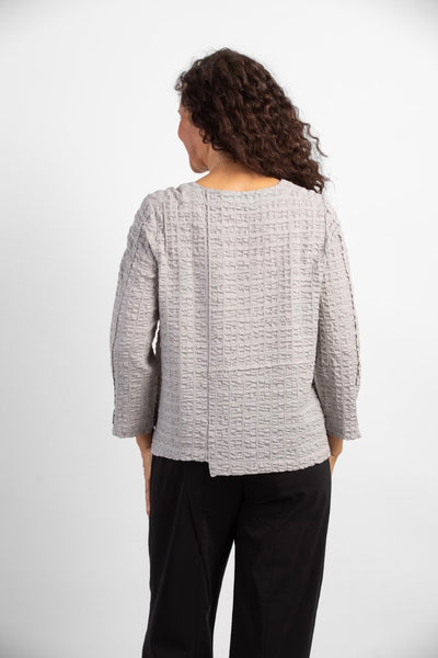 Habitat Pucker Weave Pullover in putty. Boxy shape, pucker textured fabric, exposed seam details, bracelet length sleeves, round neckline.