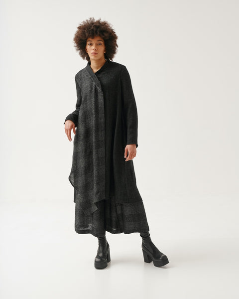 Kedziorek Linen Blend Duster. Elongated shirt with asymmetrical neckline and hem. Long sleeves, subtle black and gray pattern on front panel. Solid black back panel.