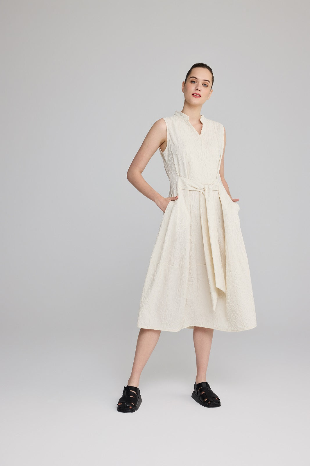 LUUKAA's Sleeveless Crinkle Wrap Dress in Cream