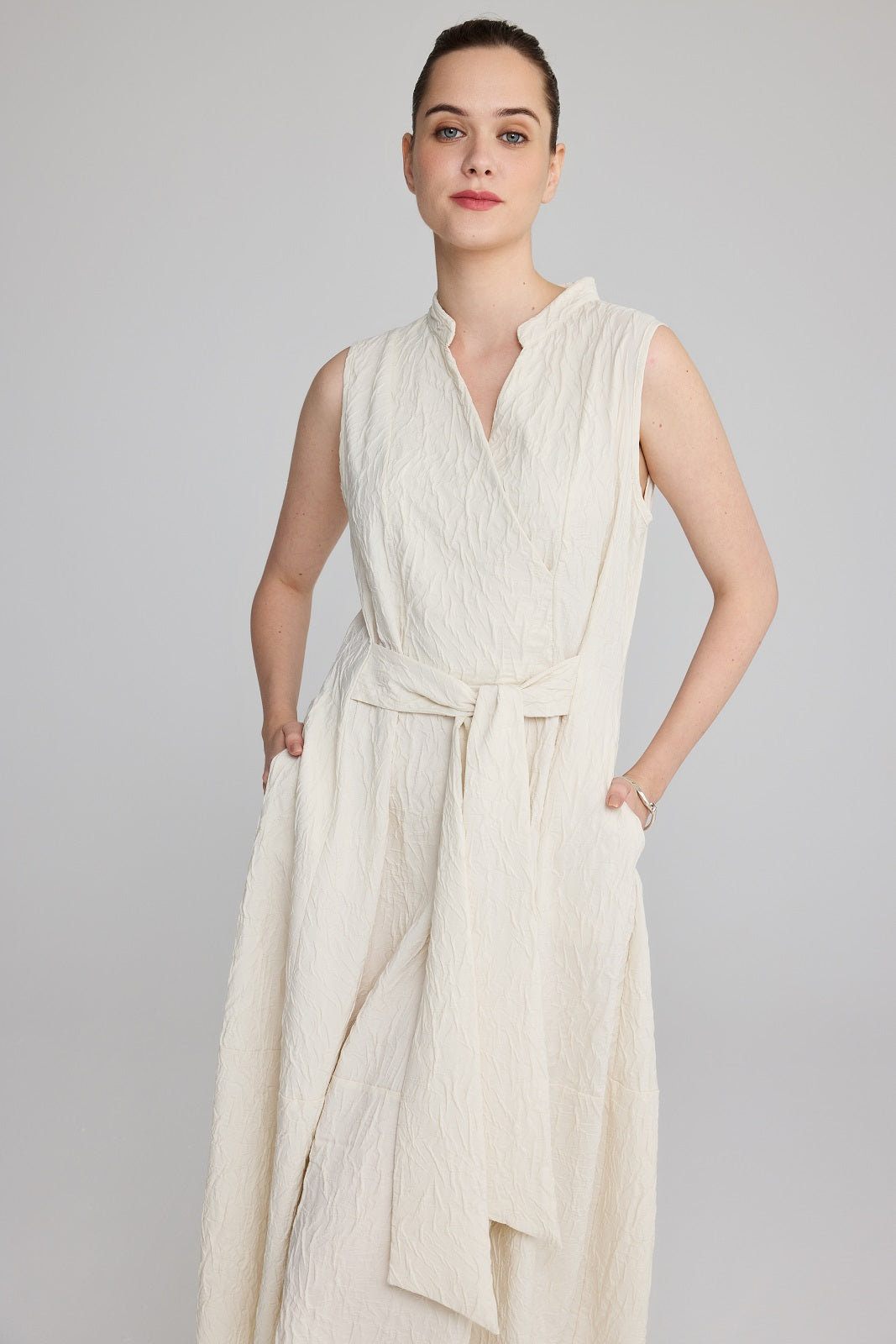 LUUKAA's Sleeveless Crinkle Wrap Dress in Cream
