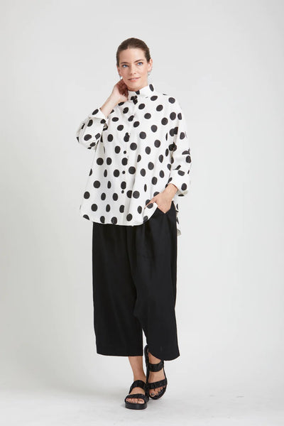 mSquare Clothing Circular Top. White cotton blend fabric with bold black polk dot pattern. Rounded hem, cropped sleeves, button up front.
