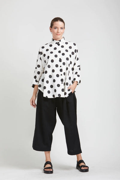 mSquare Clothing Circular Top. White cotton blend fabric with bold black polk dot pattern. Rounded hem, cropped sleeves, button up front.