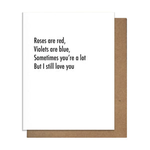 White greeting card that reads "Roses are red, violets are blue, sometimes you're a lot, but I still love you