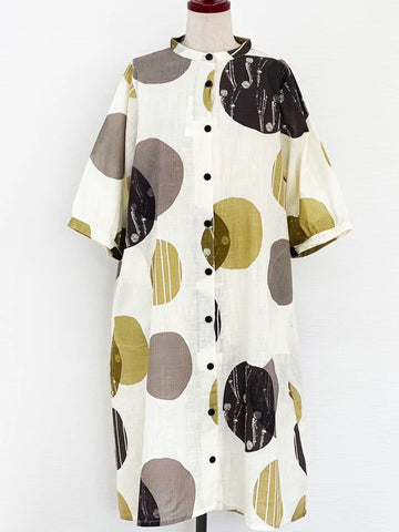 Natural white cotton slub button down dress with black, gray, brown and mustard circles printed on the fabric.