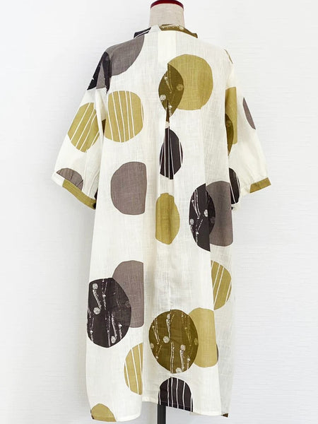 Natural white cotton slub button down dress with black, gray, brown and mustard circles printed on the fabric.