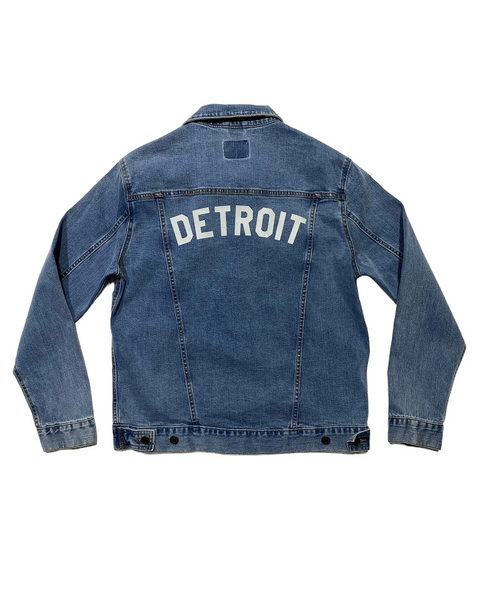 denim jacket with "detroit" in white lettering screenprinted across the back