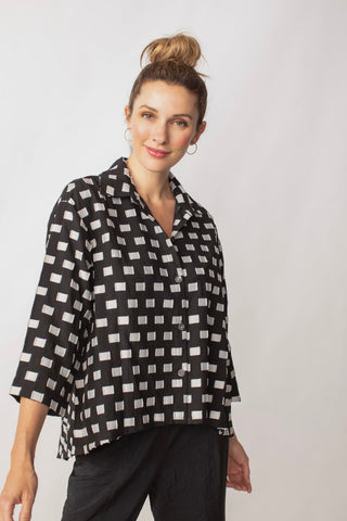 Liv by Habitat Geo Clip Dot Overlay Tunic. Button down shirt with cropped sleeves and asymmetrical hem. A-line. Black with sand rectangular pattern all over.