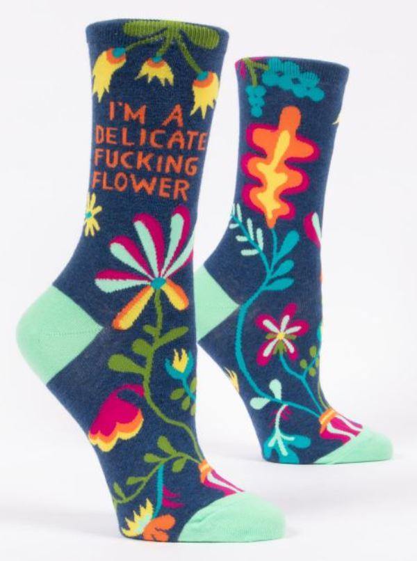 Blue crew socks with floral patterns and says "I'm a delicate f***ing flower".