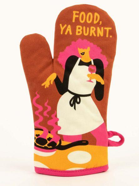 Brown oven mitt with an illustration of a girl holding a glass of wine looking at a pot of burning food. Has text that says, "Food, ya burnt."