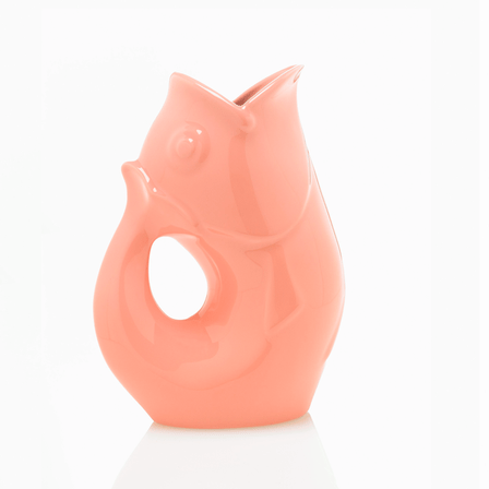 Coral pink fish shaped water vase with a handle.
