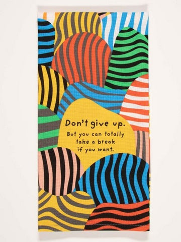 Screen printed dish towel composed of different colored blobs with stripes.  In the middle. there is a stripeless yellow blob that has text saying, "Don't give up, but you can totally ake a break if you want."