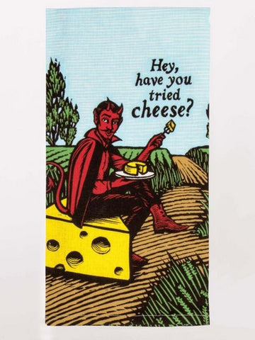 Screen printed dish towel of a red devil sitting on a block of cheese, while eating cheese, he asks, "Hey, have you tried cheese?"