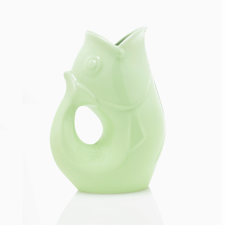 Light green fish shaped water vase with a handle.