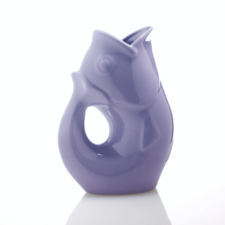 Lavender fish shaped water vase with a handle.