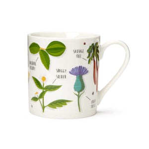 White mug with various plant designs on it.