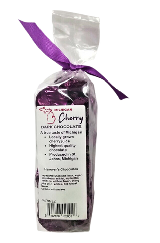 Plastic bag filled with dark cherry filled dark chocolate. Tied with a purple ribbon.